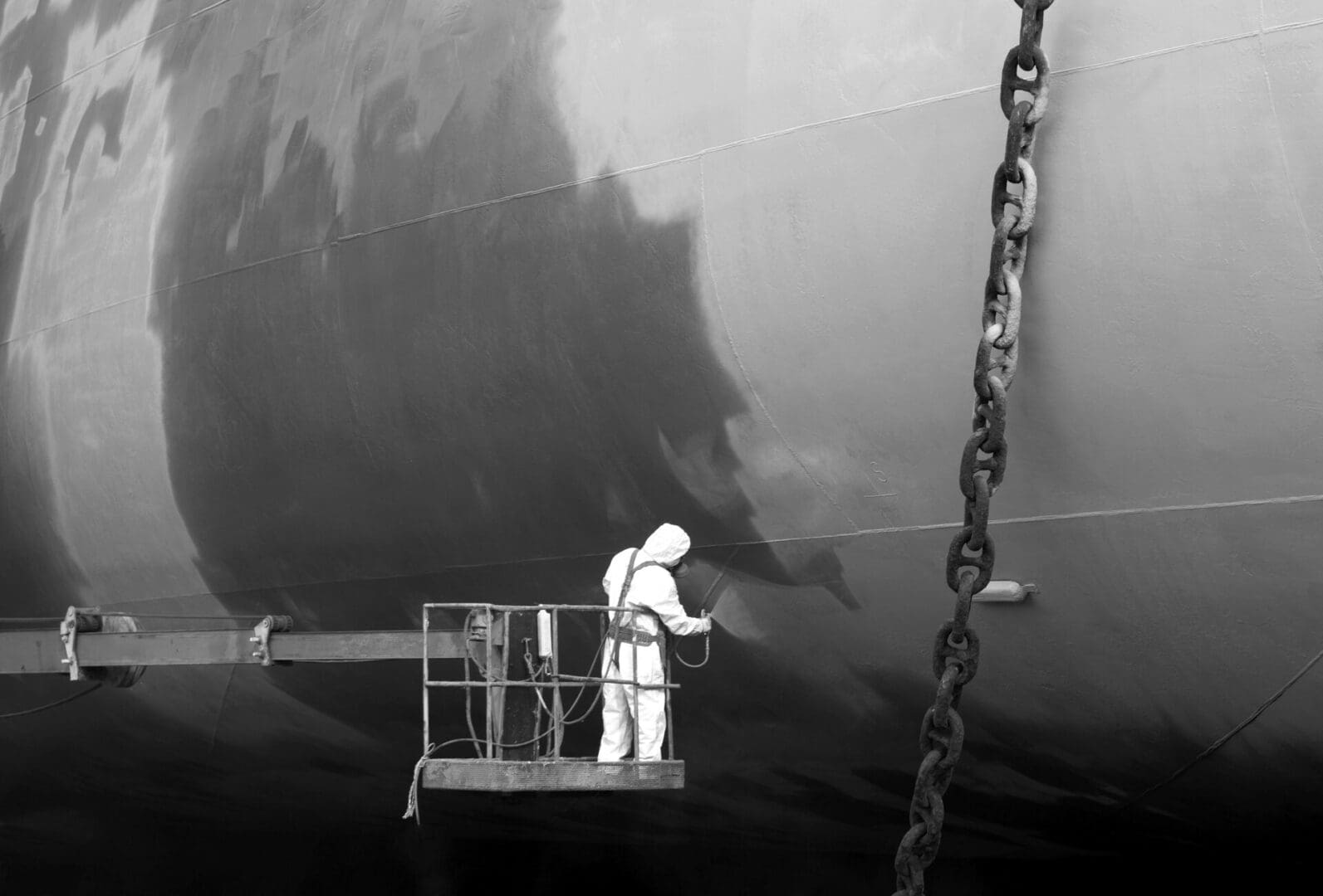 Shipyard worker paint the ship Shipyard worker paint the ship, black and white.